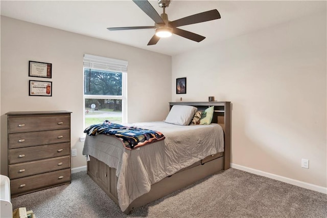 carpeted bedroom with ceiling fan and baseboards