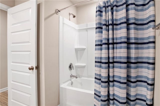 bathroom featuring shower / bath combination with curtain and wood finished floors