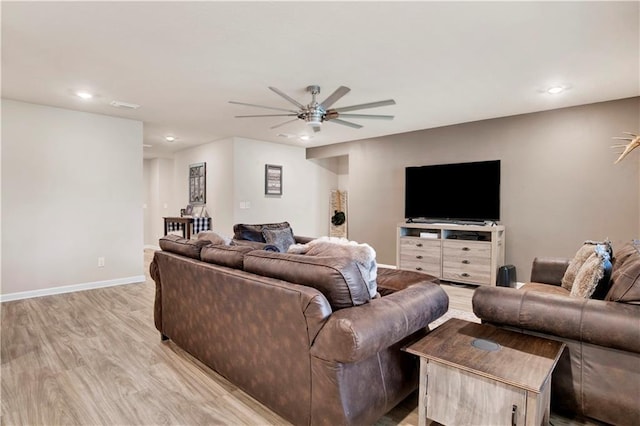 living room with light wood-style flooring, baseboards, a ceiling fan, and recessed lighting