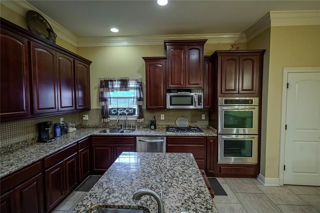 kitchen featuring backsplash, stainless steel appliances, sink, crown molding, and light stone countertops