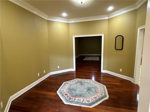 empty room featuring hardwood / wood-style floors and ornamental molding