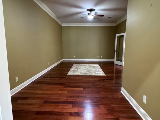 empty room featuring ceiling fan, crown molding, dark wood-type flooring, and a textured ceiling