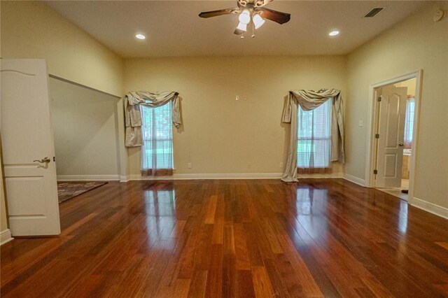 unfurnished room featuring a wealth of natural light, hardwood / wood-style floors, and ceiling fan