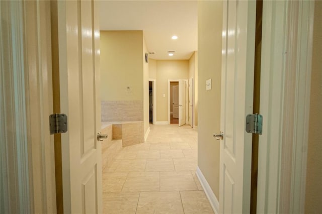 hallway featuring light tile patterned floors