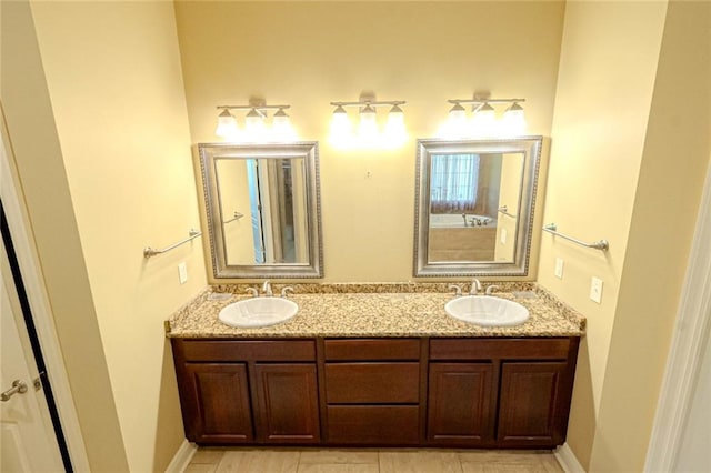 bathroom with double vanity and tile patterned floors