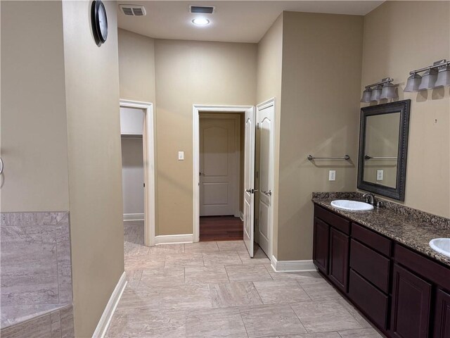 bathroom with double sink vanity and tile patterned floors