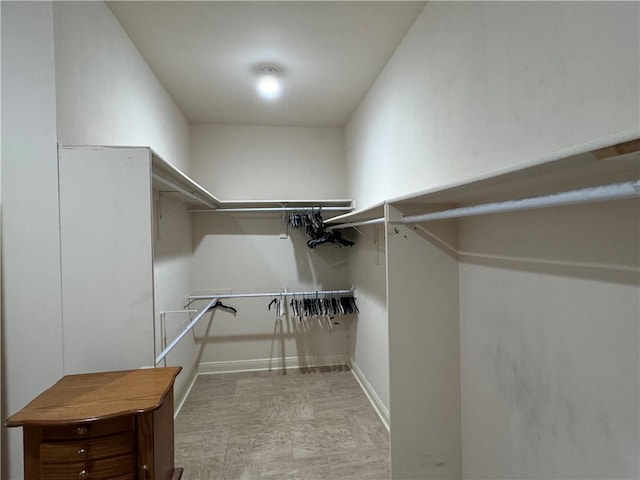 spacious closet with light tile patterned floors