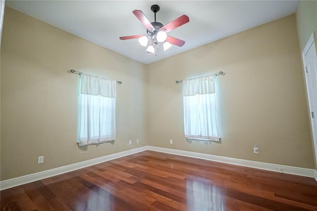 empty room featuring plenty of natural light, ceiling fan, and hardwood / wood-style flooring