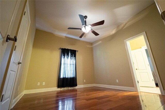 unfurnished room with ceiling fan and wood-type flooring