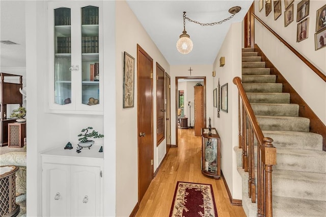 interior space featuring stairway, visible vents, and light wood-style floors