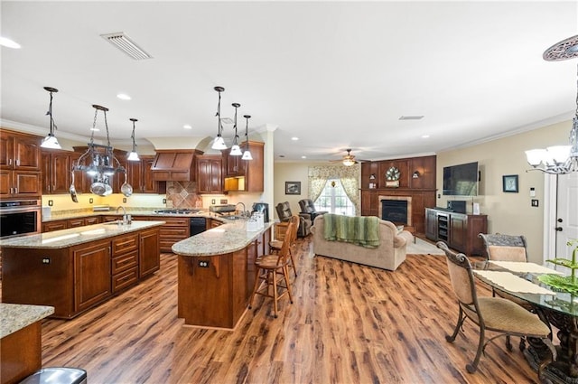 7180 Cannon Ball Cir, Bay Minette, AL 36507 - kitchen with a kitchen bar, visible vents, wood finished floors, a sink, and stainless steel appliances