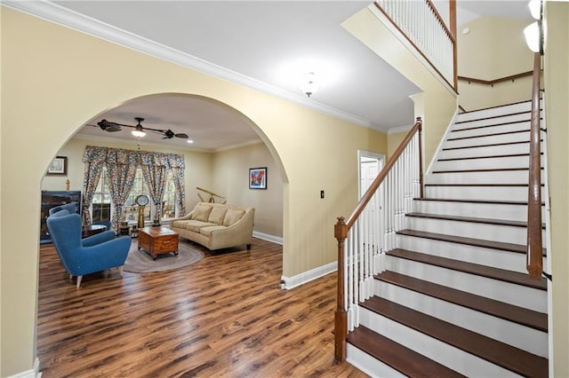 7180 Cannon Ball Cir, Bay Minette, AL 36507 - stairs featuring crown molding, arched walkways, baseboards, and wood finished floors