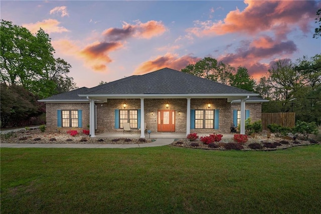 7180 Cannon Ball Cir, Bay Minette, AL 36507 - rear view of house with a porch, fence, a yard, and brick siding