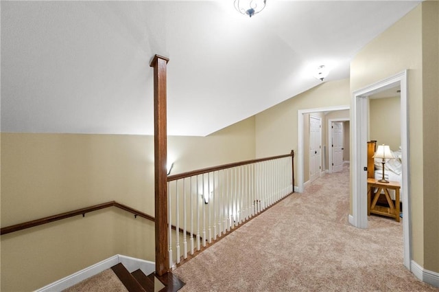 7180 Cannon Ball Cir, Bay Minette, AL 36507 - corridor with baseboards, vaulted ceiling, carpet flooring, and an upstairs landing