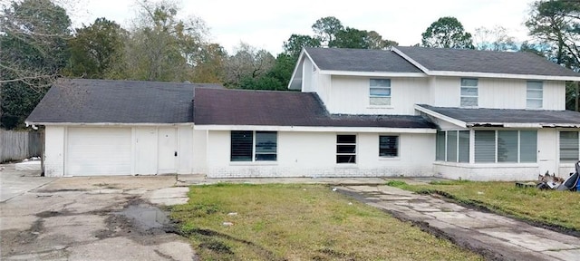 view of front of home with a front yard and a garage