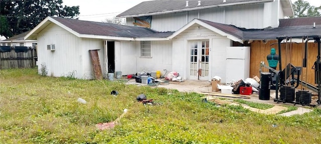 rear view of property featuring a lawn