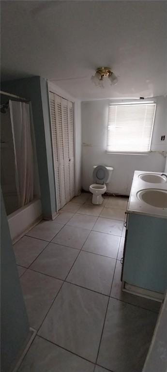 bathroom featuring shower / bathtub combination with curtain, tile patterned floors, and vanity