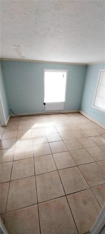 unfurnished room featuring light tile patterned floors