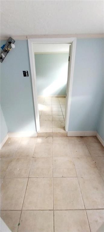 corridor featuring light tile patterned floors