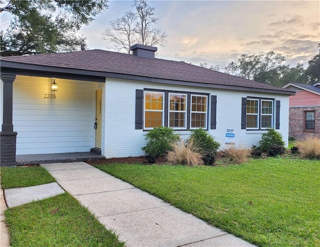 ranch-style house with a yard