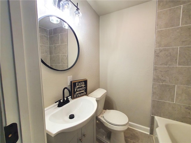 bathroom featuring tile patterned flooring, vanity, and toilet