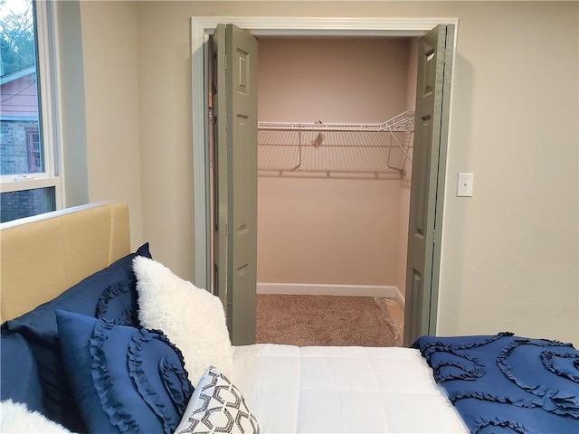 carpeted bedroom with a closet