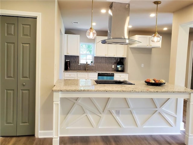 kitchen with island exhaust hood, white cabinets, and hanging light fixtures