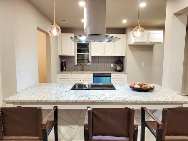 kitchen featuring pendant lighting, white cabinets, light stone countertops, black electric cooktop, and island range hood