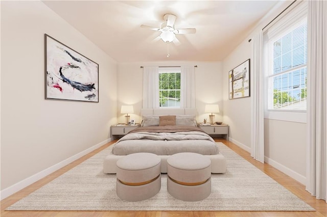 bedroom with ceiling fan and light hardwood / wood-style flooring