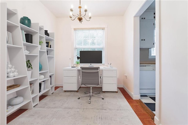 office area featuring light parquet floors and a notable chandelier