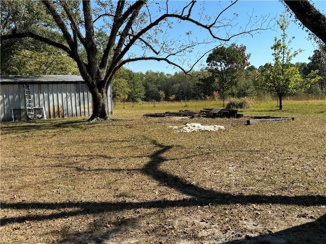 view of yard featuring an outbuilding and a pole building