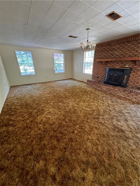 unfurnished living room featuring a notable chandelier, carpet, and visible vents