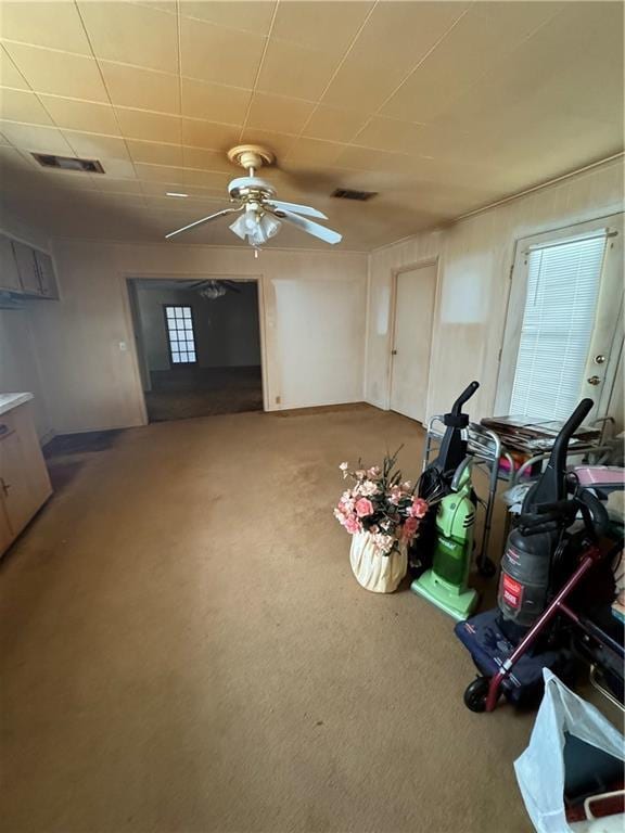 interior space featuring visible vents and a ceiling fan