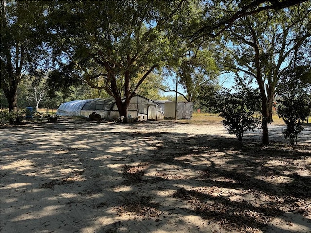 view of yard with an outdoor structure and an exterior structure