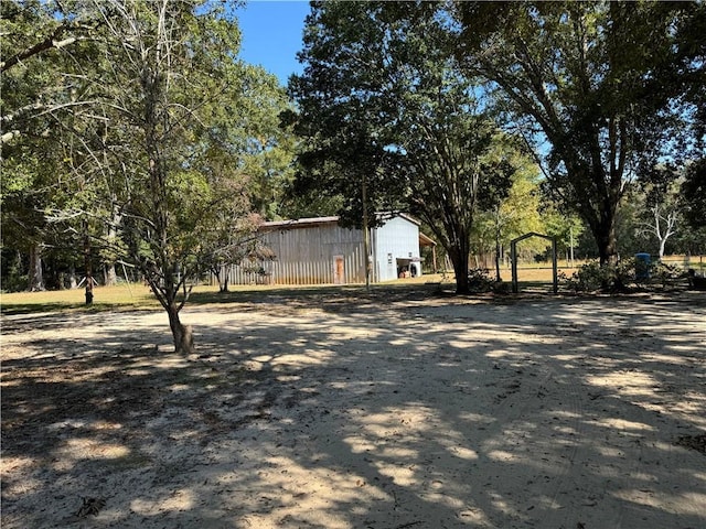 view of yard with an outbuilding and a pole building