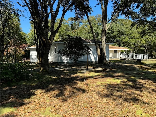 view of yard with a garage and a wooden deck