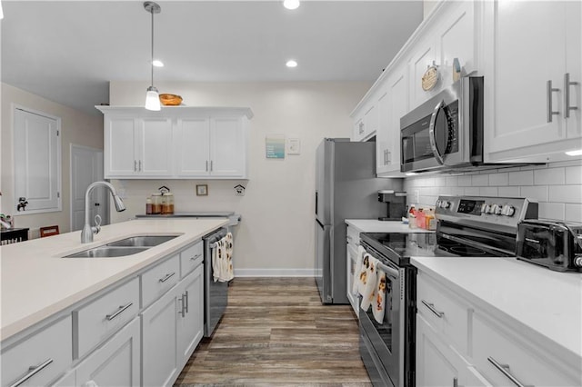 908 Longfellow Pl, Dauphin Island, AL 36528 - kitchen with appliances with stainless steel finishes, a sink, white cabinets, light countertops, and recessed lighting