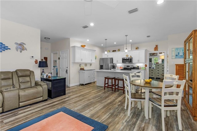 908 Longfellow Pl, Dauphin Island, AL 36528 - dining room featuring wood finished floors, recessed lighting, a ceiling fan, and baseboards