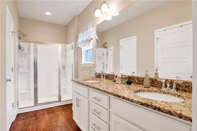 bathroom featuring an enclosed shower, vanity, and hardwood / wood-style floors