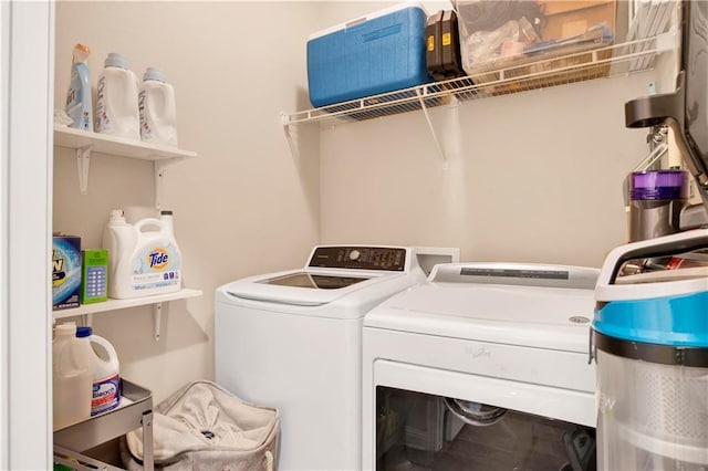 clothes washing area with washing machine and clothes dryer