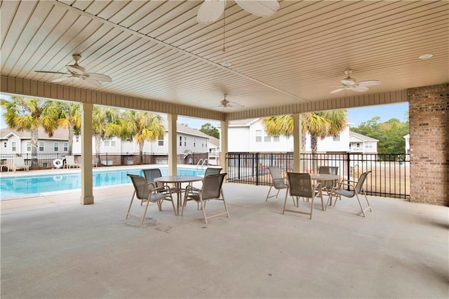 view of patio featuring ceiling fan and a community pool