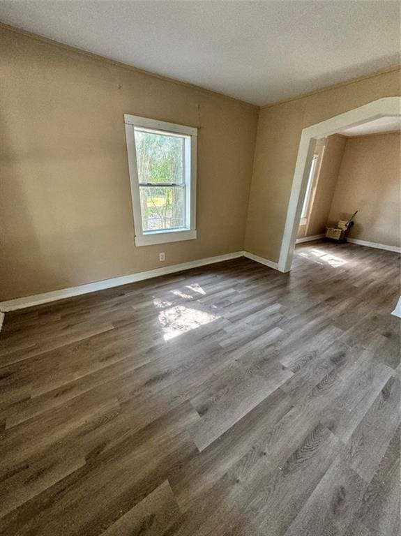 empty room featuring a textured ceiling and hardwood / wood-style flooring