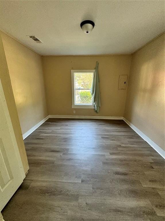 unfurnished room with a textured ceiling and hardwood / wood-style flooring