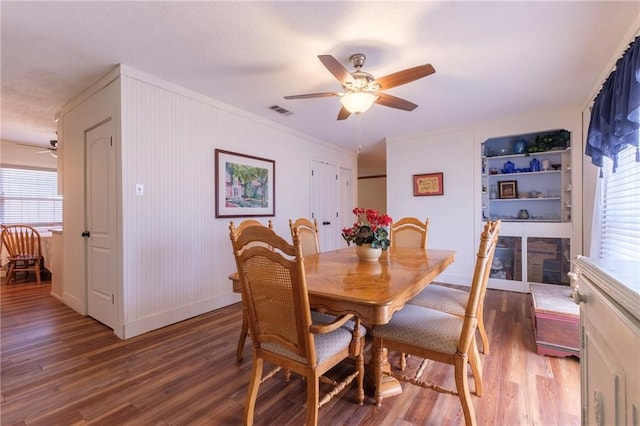 dining area with ceiling fan, dark wood-type flooring, and a healthy amount of sunlight