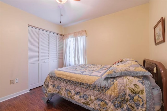 bedroom with a closet, dark hardwood / wood-style floors, and ceiling fan