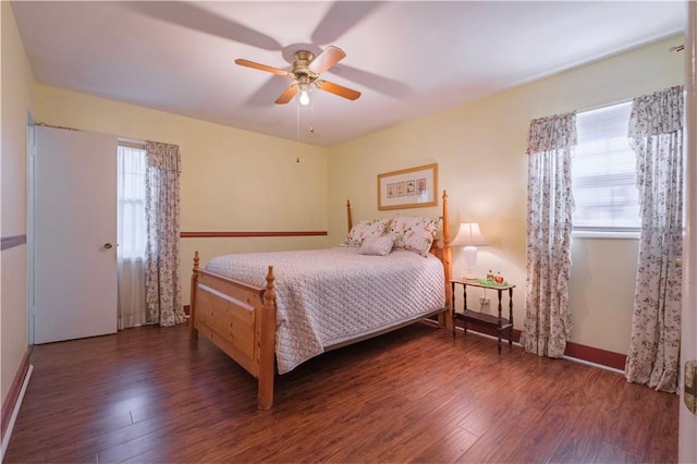 bedroom with ceiling fan and dark wood-type flooring