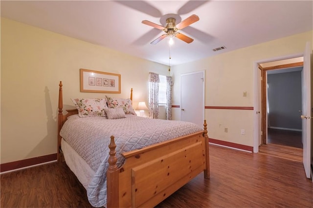 bedroom with dark hardwood / wood-style floors and ceiling fan