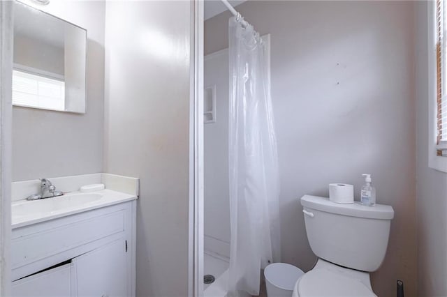 bathroom with vanity, a shower with shower curtain, and toilet