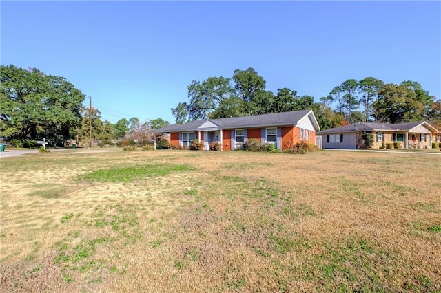 ranch-style home with a front lawn