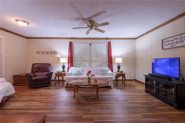 living room featuring a textured ceiling, dark hardwood / wood-style floors, ceiling fan, and crown molding